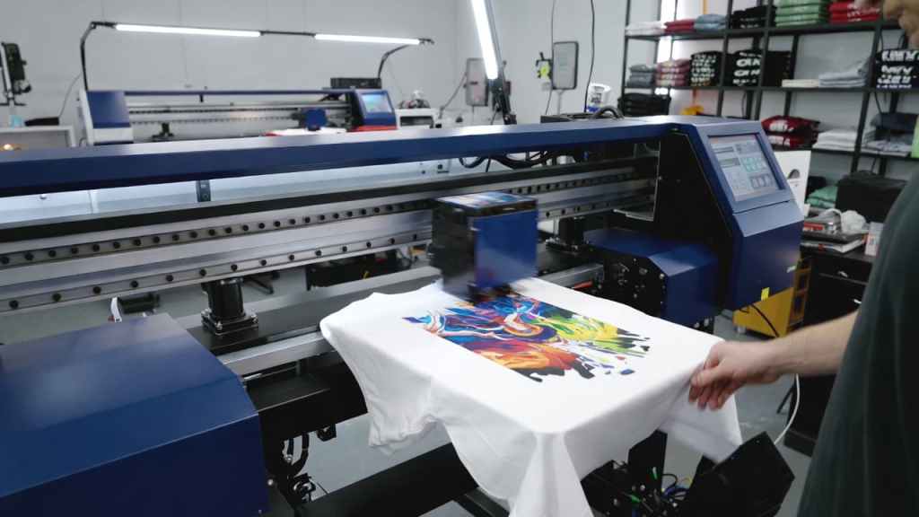DTG printing machine producing custom t-shirt design in a professional print studio